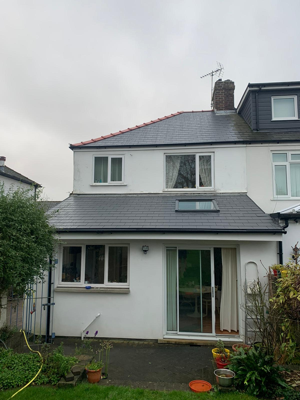 A completed roof extension with new tiles and a skylight